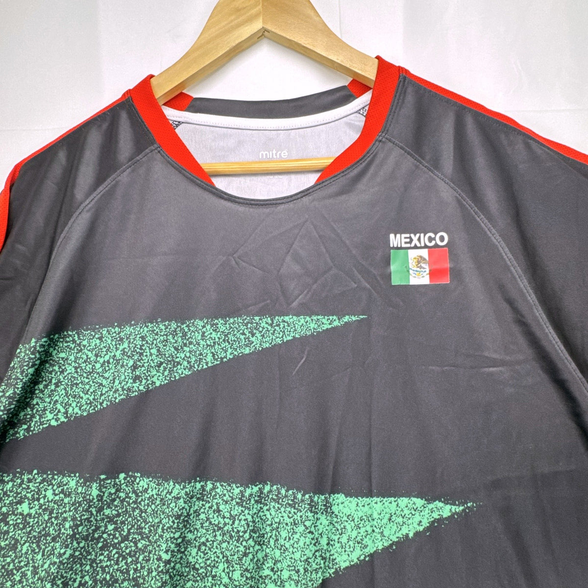 Mitre Mexico soccer jersey in black with green geometric print and red trim, men's size XL.
