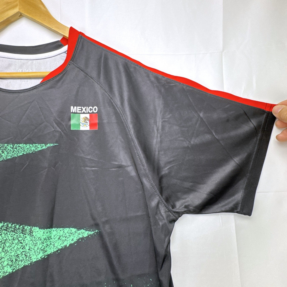 Mitre Mexico soccer jersey in black with green geometric print and red trim, men's size XL.