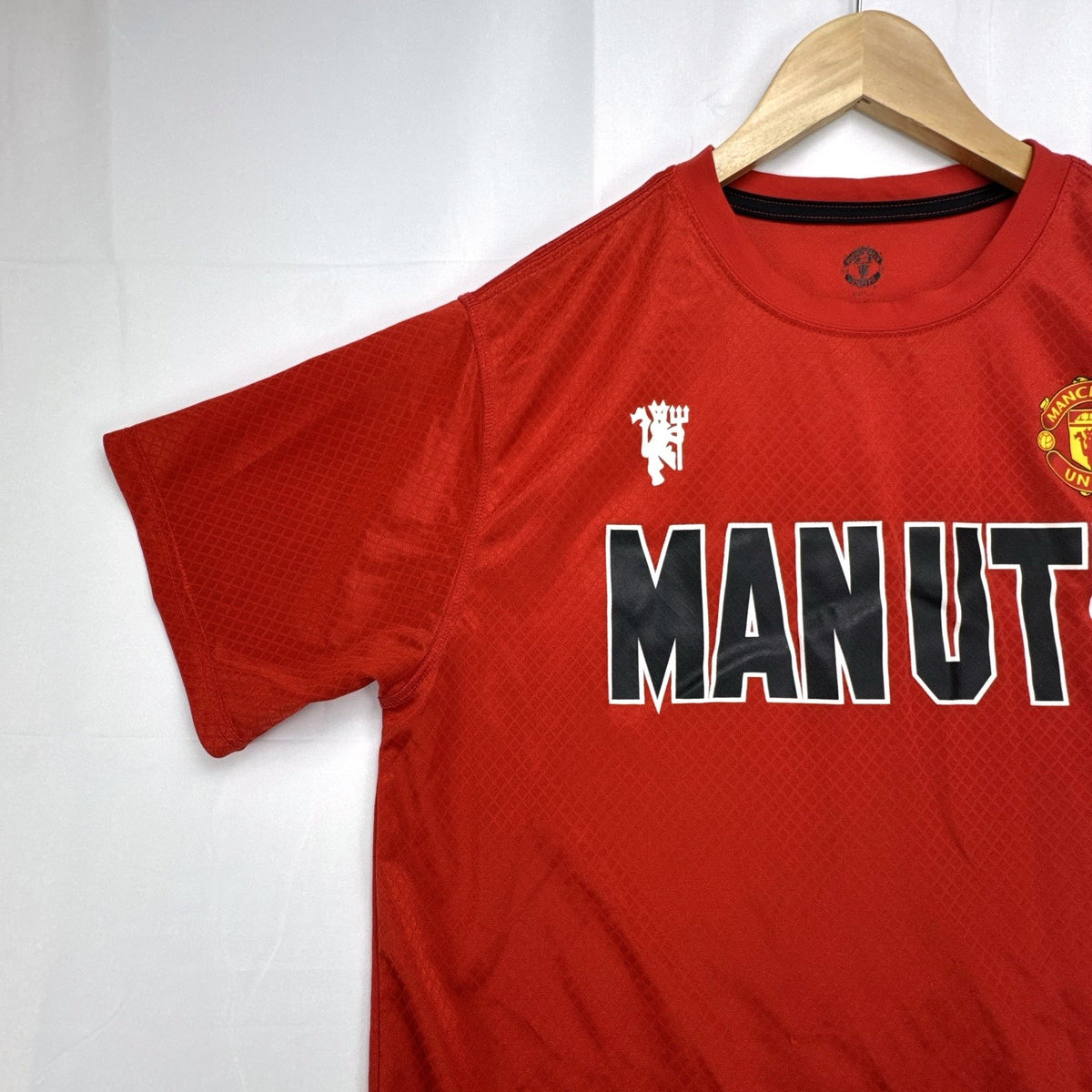 Manchester United men's red soccer jersey in size XL with chest crest and diamond knit pattern