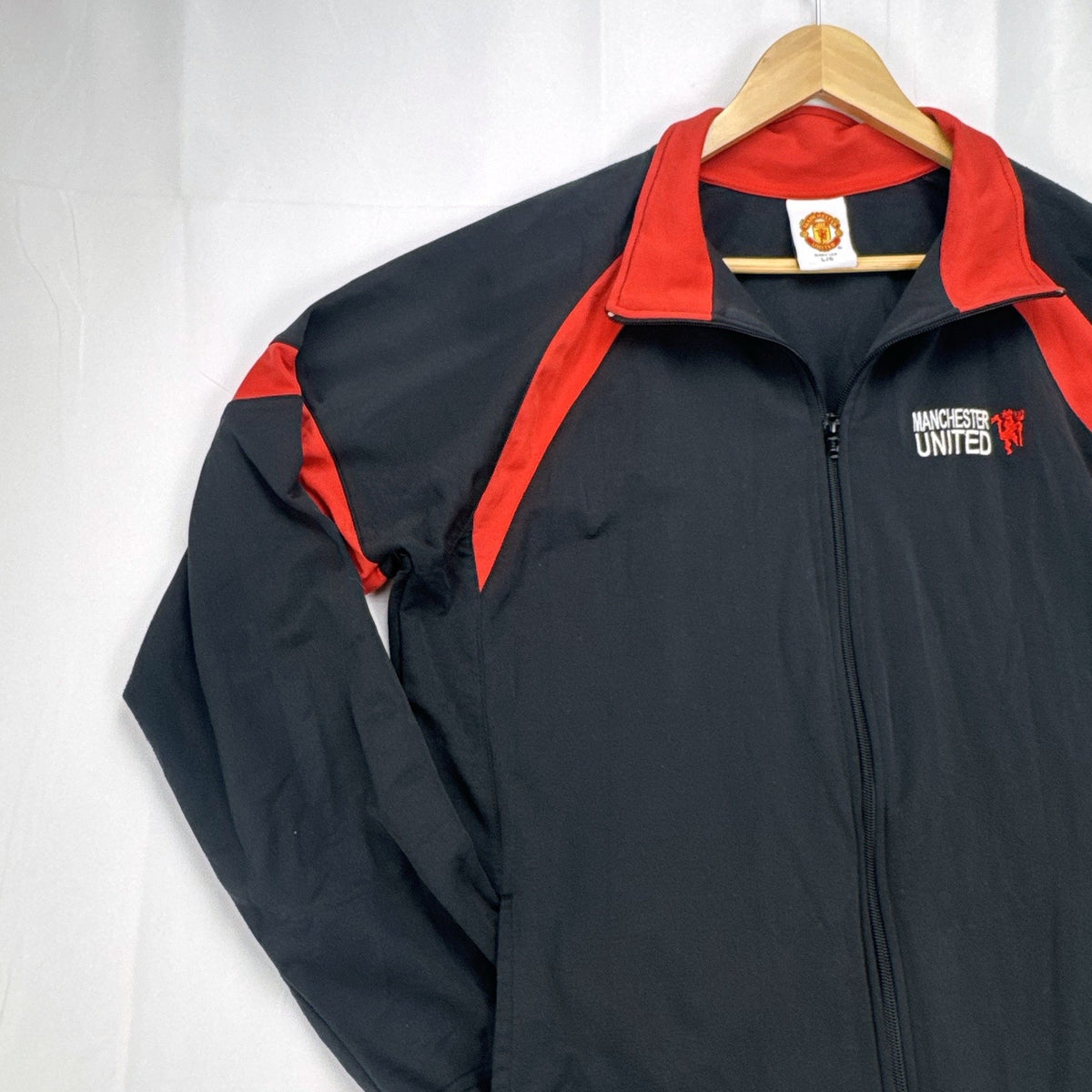 Manchester United men's large full-zip track jacket in black and red with embroidered club crest