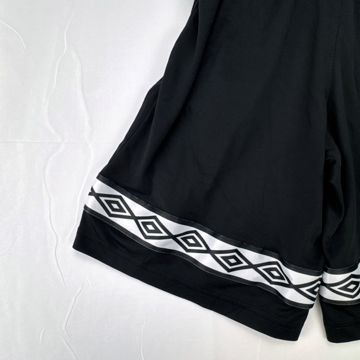 Umbro men's black athletic soccer shorts with diamond logo tape in size Small