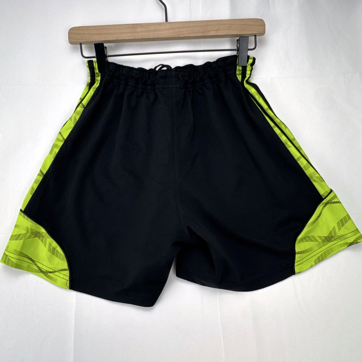 Women's black and neon green adidas soccer shorts featuring 3-Stripes sides in size Large.