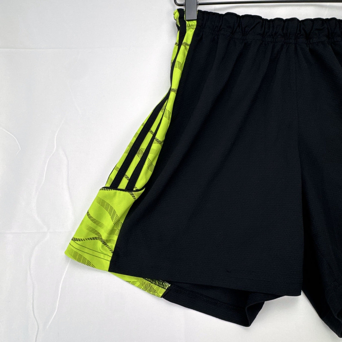 Women's black and neon green adidas soccer shorts featuring 3-Stripes sides in size Large.