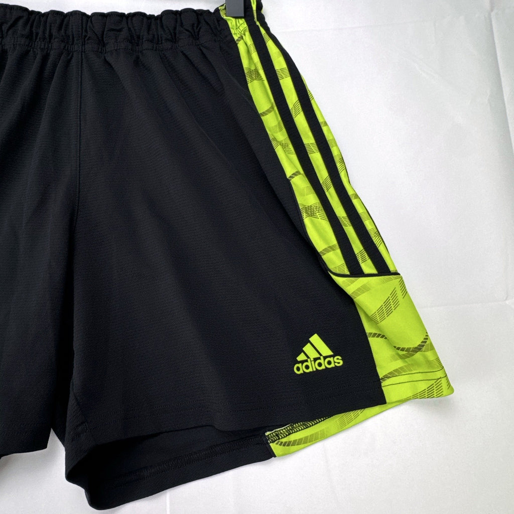 Women's black and neon green adidas soccer shorts featuring 3-Stripes sides in size Large.
