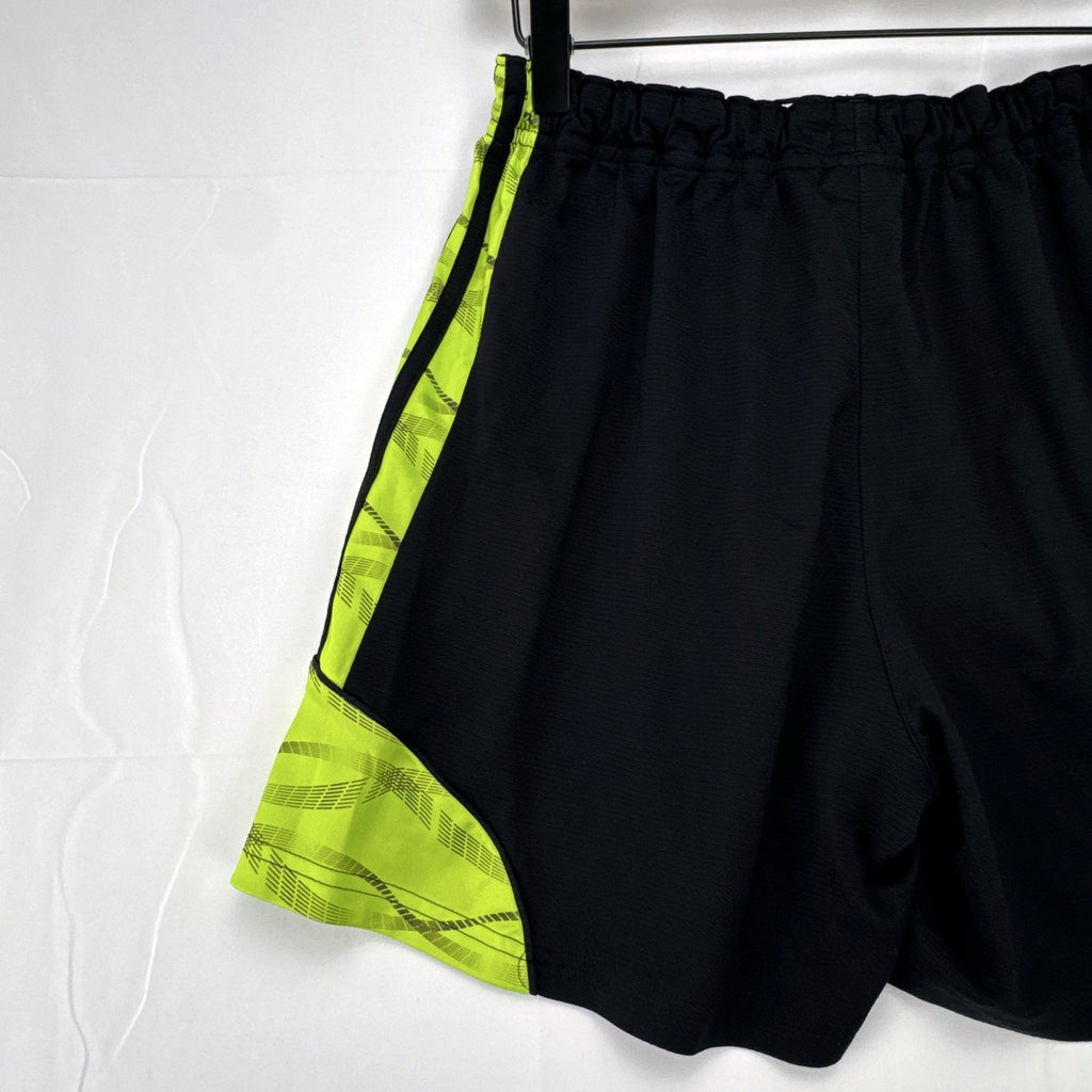 Women's black and neon green adidas soccer shorts featuring 3-Stripes sides in size Large.