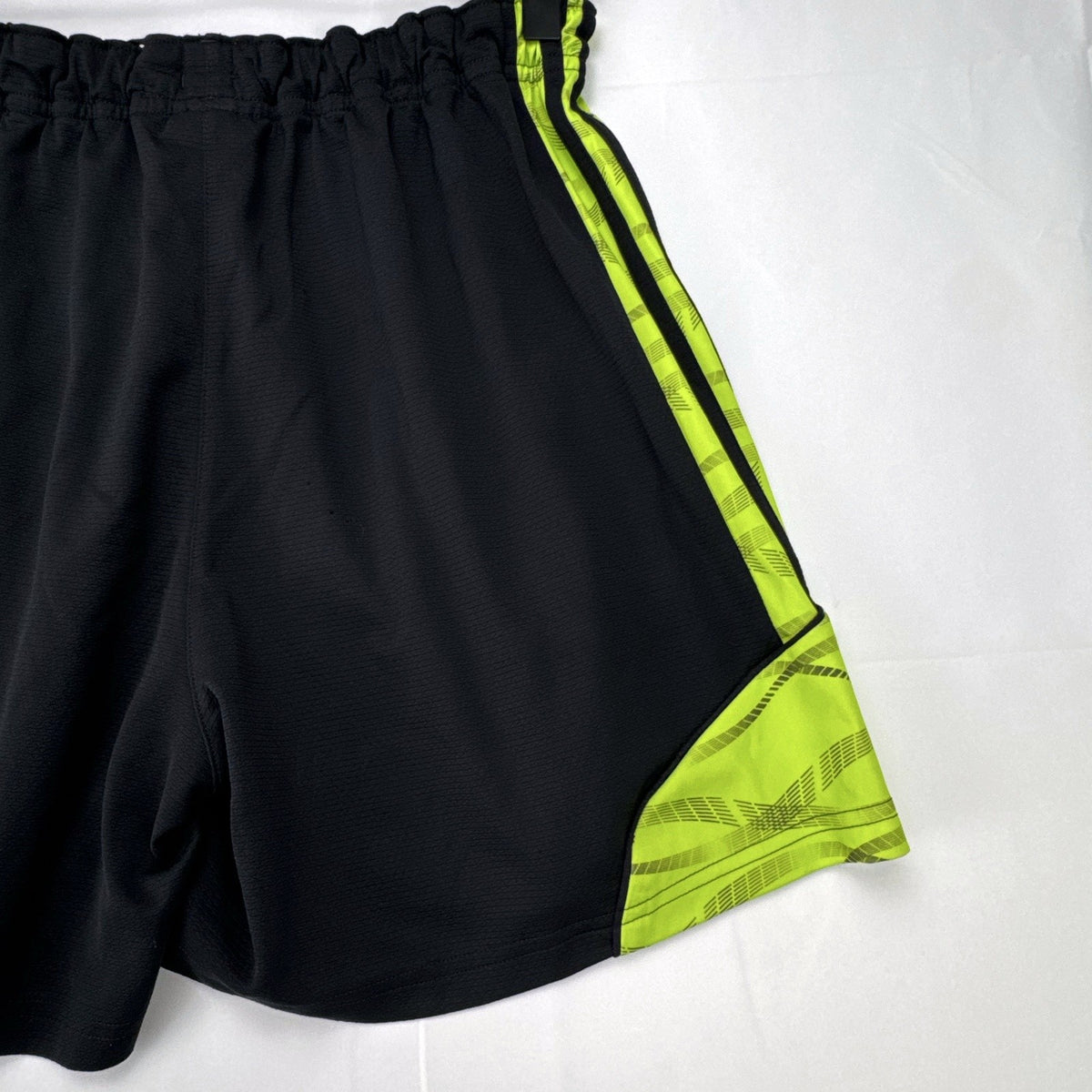 Women's black and neon green adidas soccer shorts featuring 3-Stripes sides in size Large.