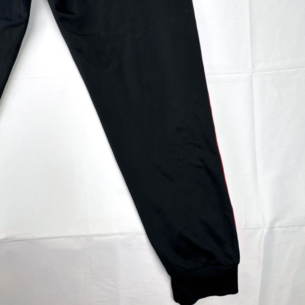 Manchester United men's black and red jogger track pants with club crest in size S