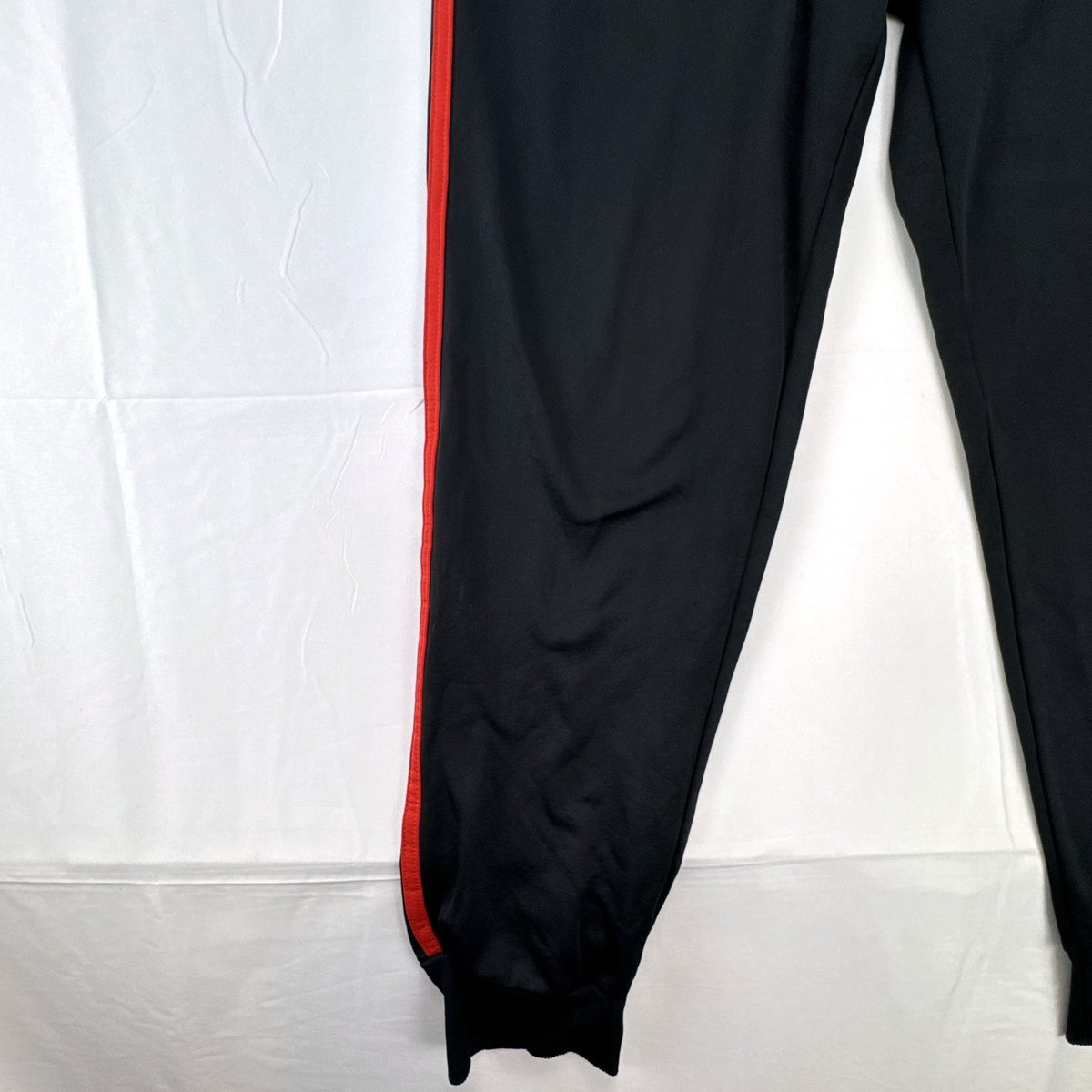 Manchester United men's black and red jogger track pants with club crest in size S
