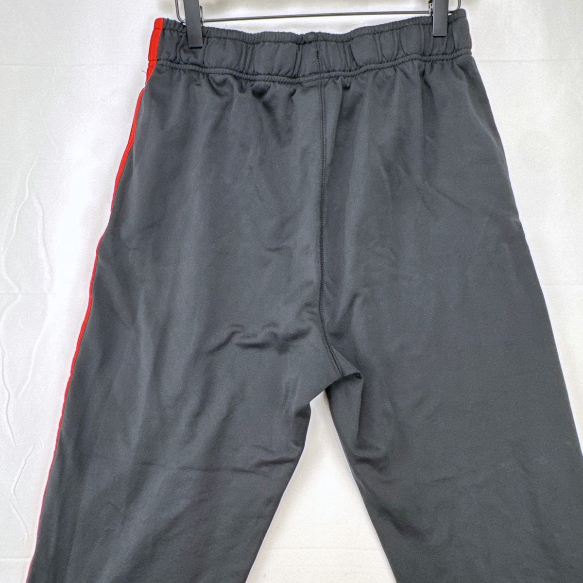 Manchester United men's black and red jogger track pants with club crest in size S