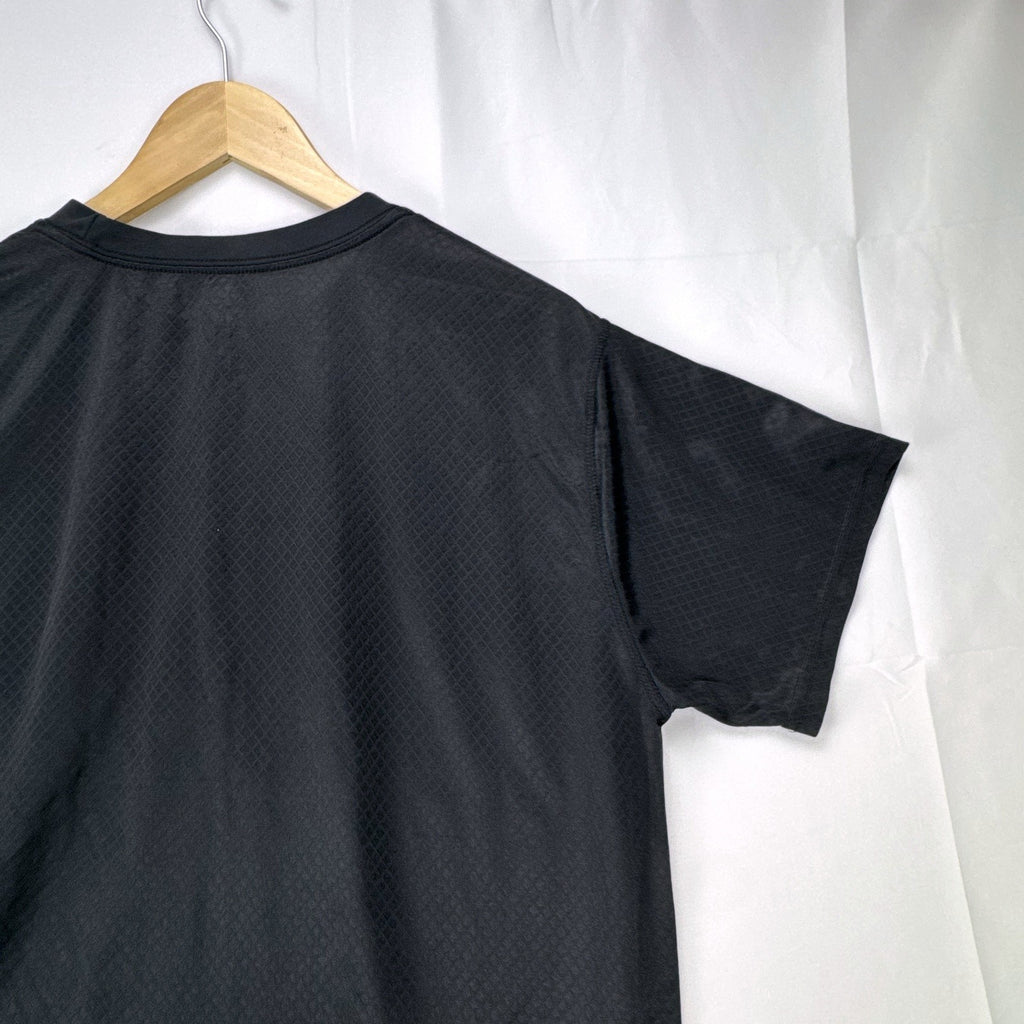 Front view of official Manchester United black short sleeve training jersey in men's size XL.