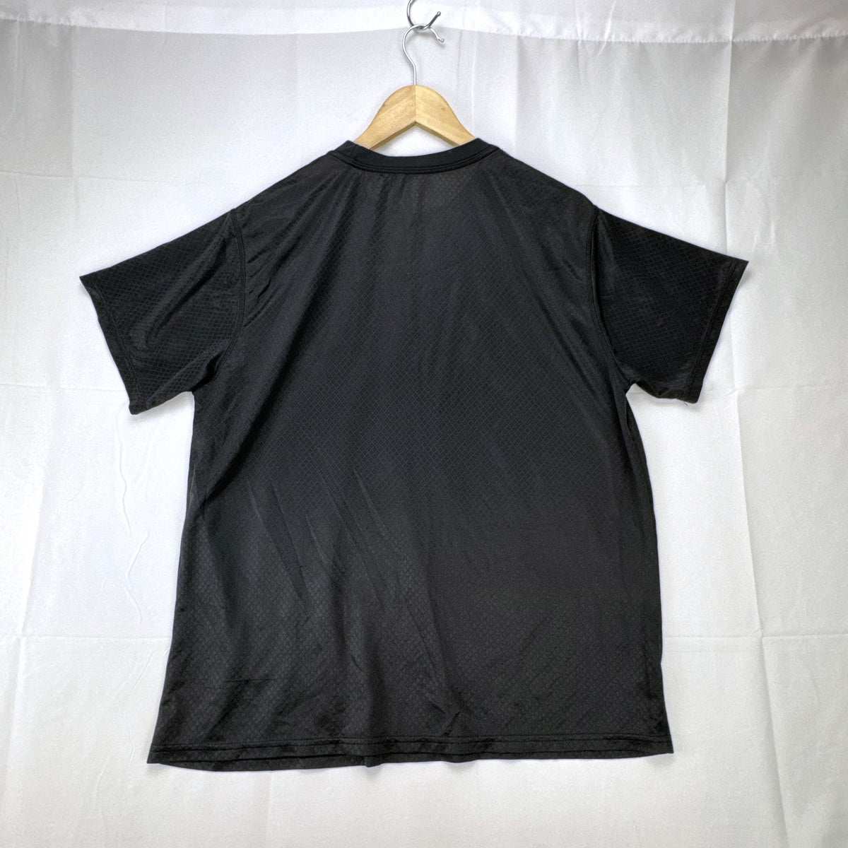 Front view of official Manchester United black short sleeve training jersey in men's size XL.