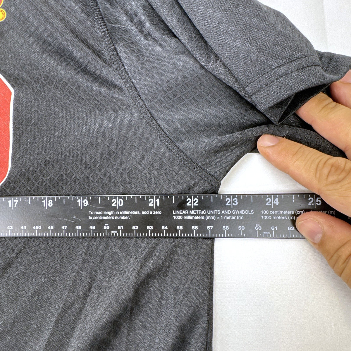 Front view of official Manchester United black short sleeve training jersey in men's size XL.