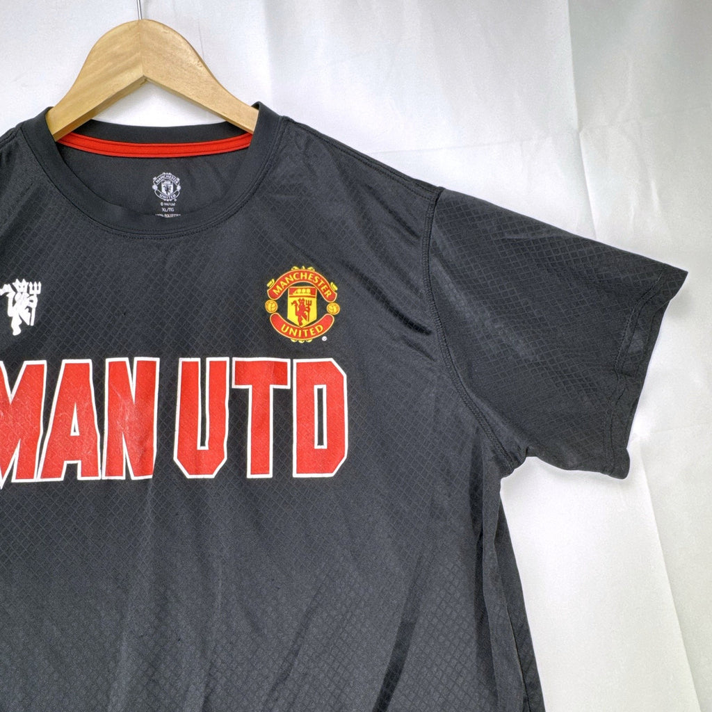 Front view of official Manchester United black short sleeve training jersey in men's size XL.