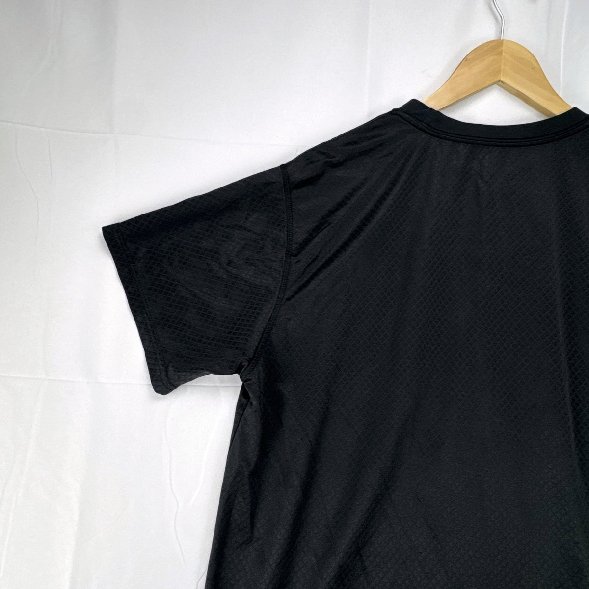 Front view of official Manchester United black short sleeve training jersey in men's size XL.