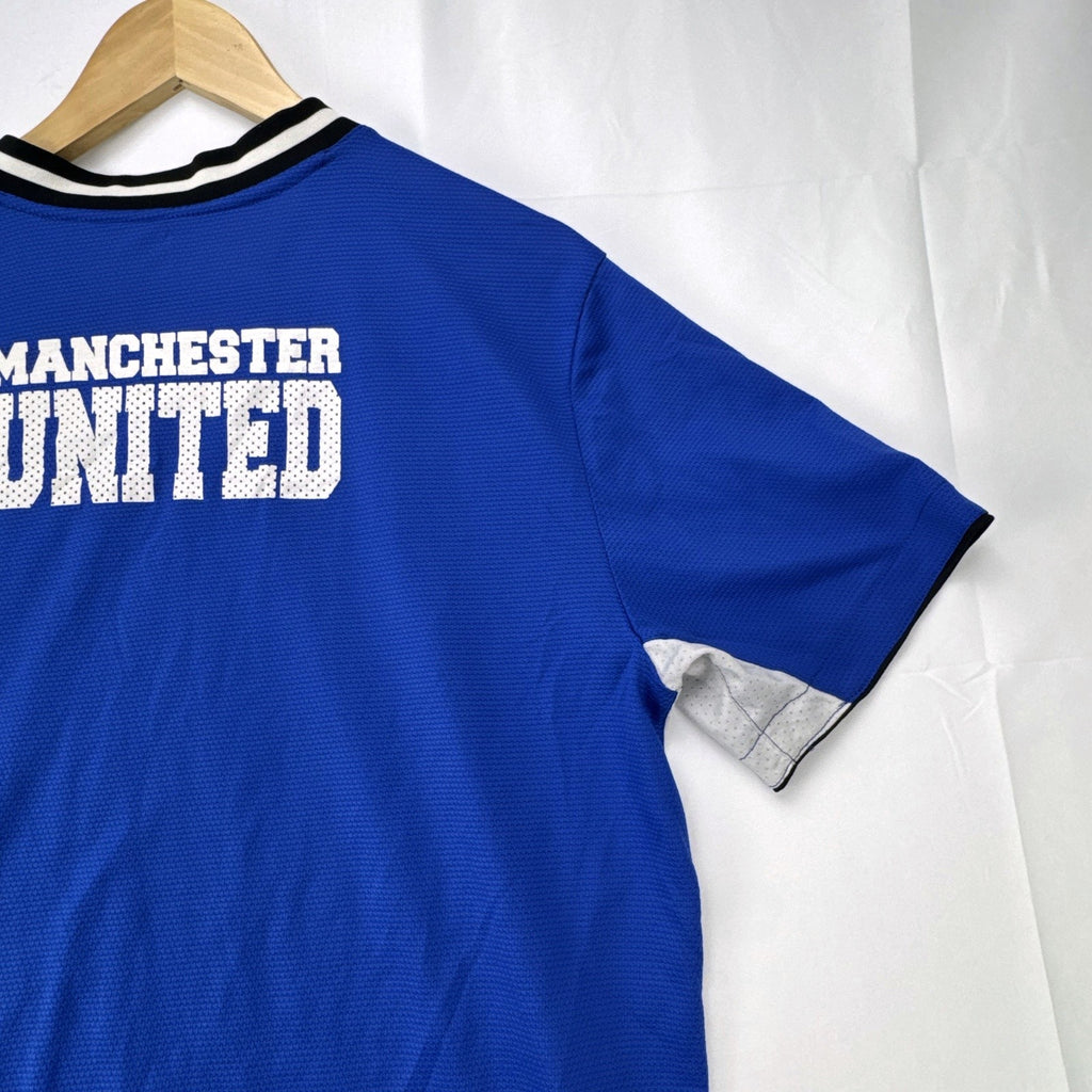 Manchester United men's large royal blue soccer jersey with embroidered chest crest and striped ribbed collar.