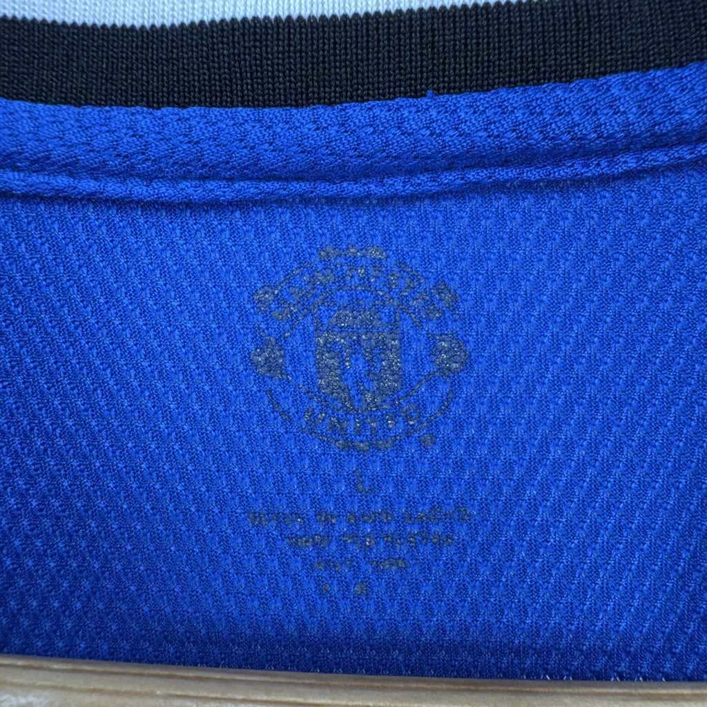 Manchester United men's large royal blue soccer jersey with embroidered chest crest and striped ribbed collar.