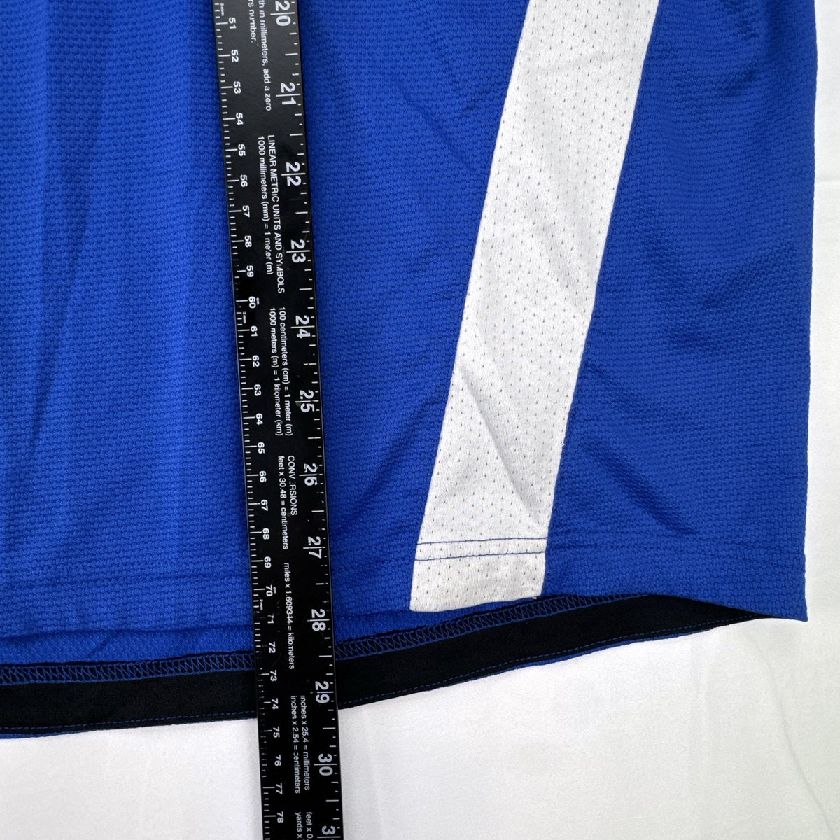 Manchester United men's large royal blue soccer jersey with embroidered chest crest and striped ribbed collar.
