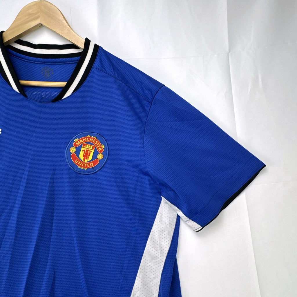 Manchester United men's large royal blue soccer jersey with embroidered chest crest and striped ribbed collar.