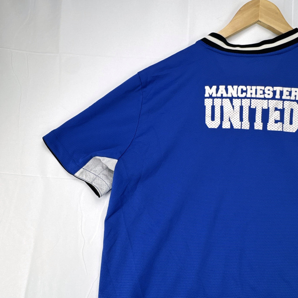 Manchester United men's large royal blue soccer jersey with embroidered chest crest and striped ribbed collar.
