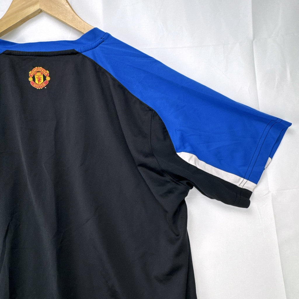 Manchester United men's soccer jersey in black with blue shoulder panels and embroidered crest