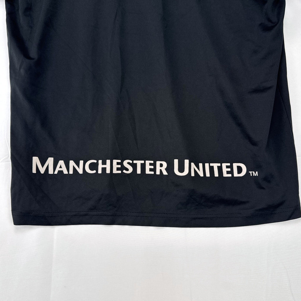 Manchester United men's soccer jersey in black with blue shoulder panels and embroidered crest