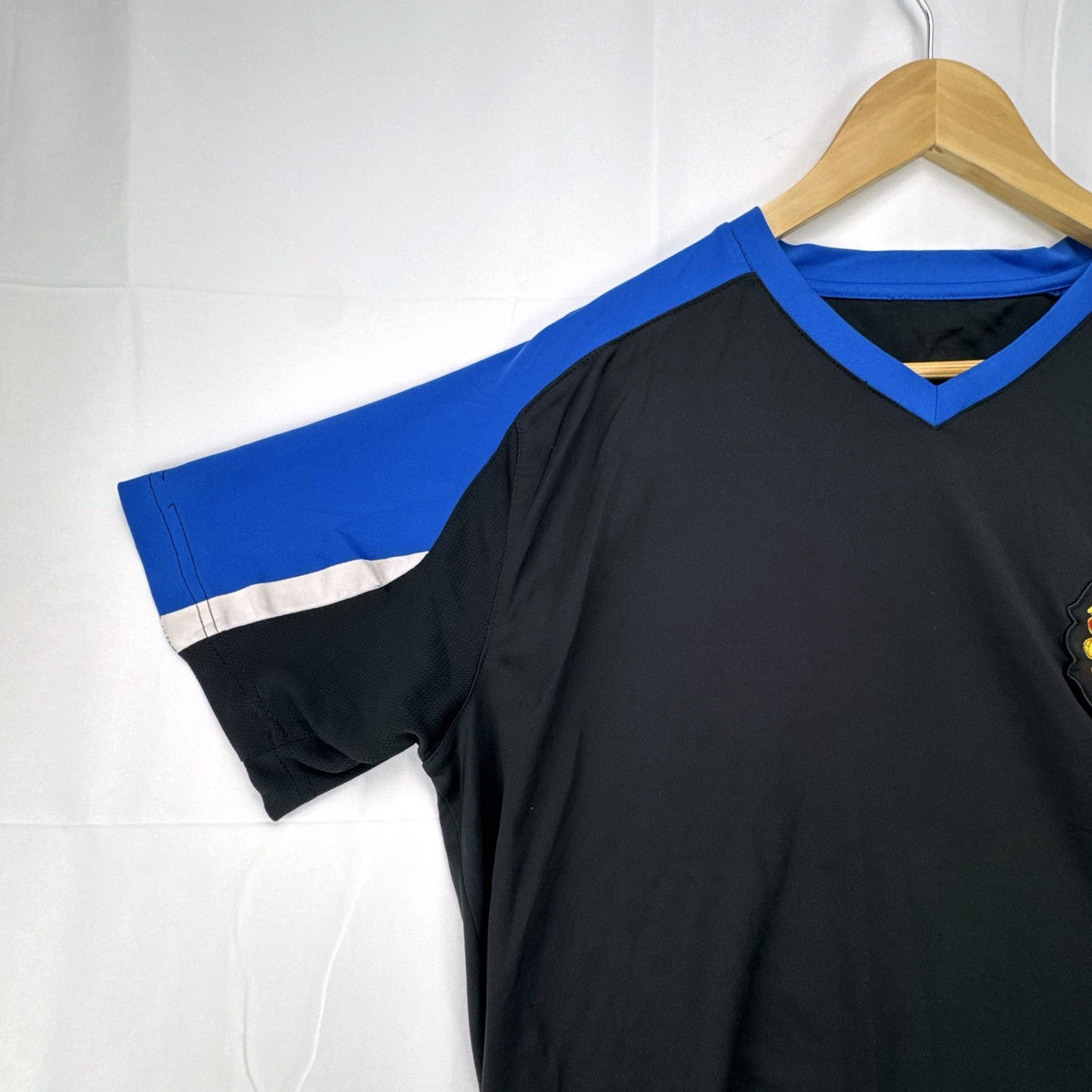 Manchester United men's soccer jersey in black with blue shoulder panels and embroidered crest