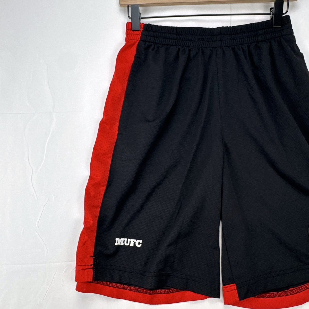 Manchester United men's black and red soccer shorts in size small with woven team crest and embroidered MUFC lettering
