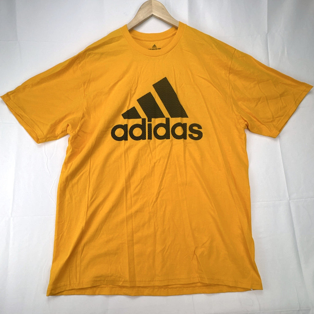 Front view of yellow adidas The Go-To graphic t-shirt in men's XL with black Badge of Sport logo