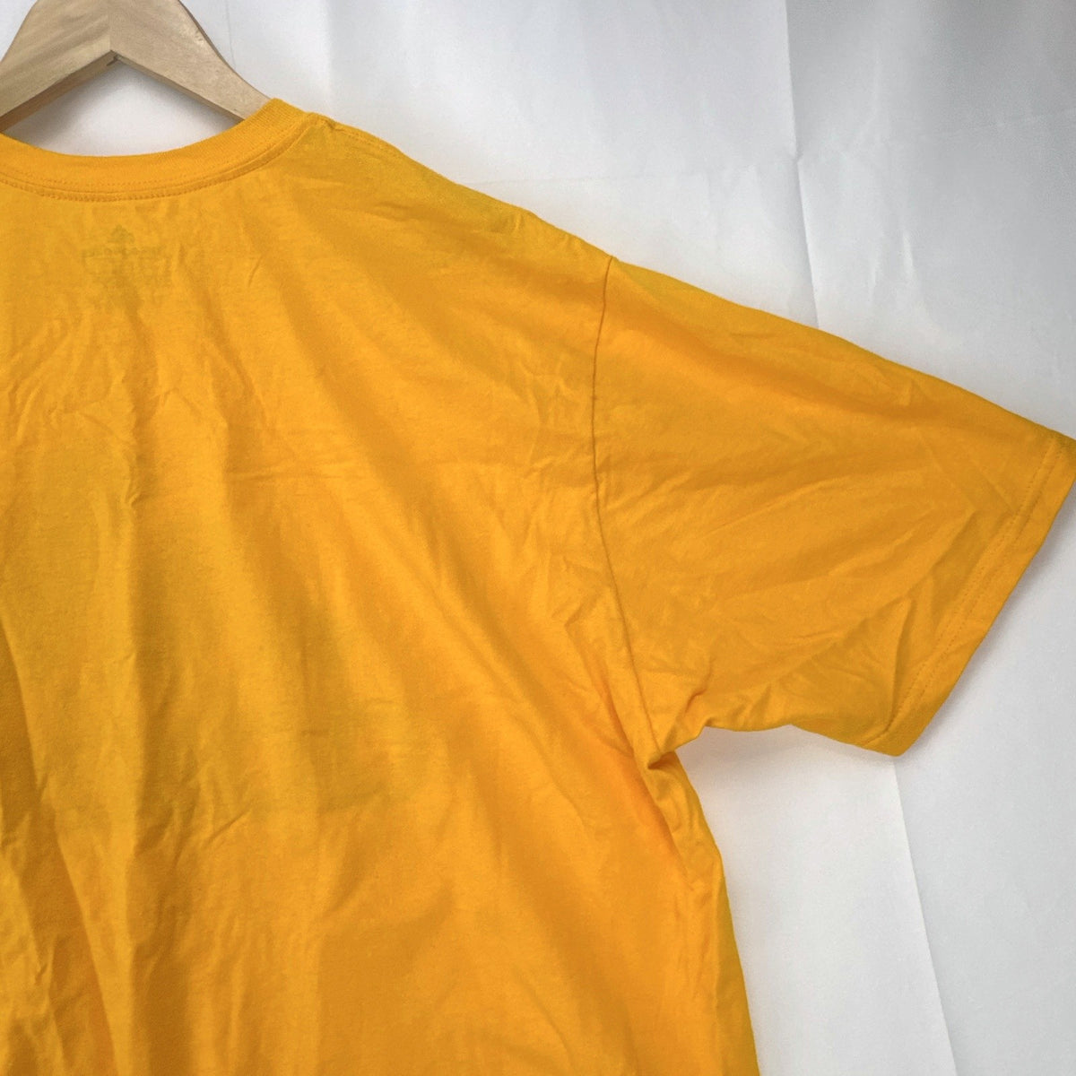 Front view of yellow adidas The Go-To graphic t-shirt in men's XL with black Badge of Sport logo