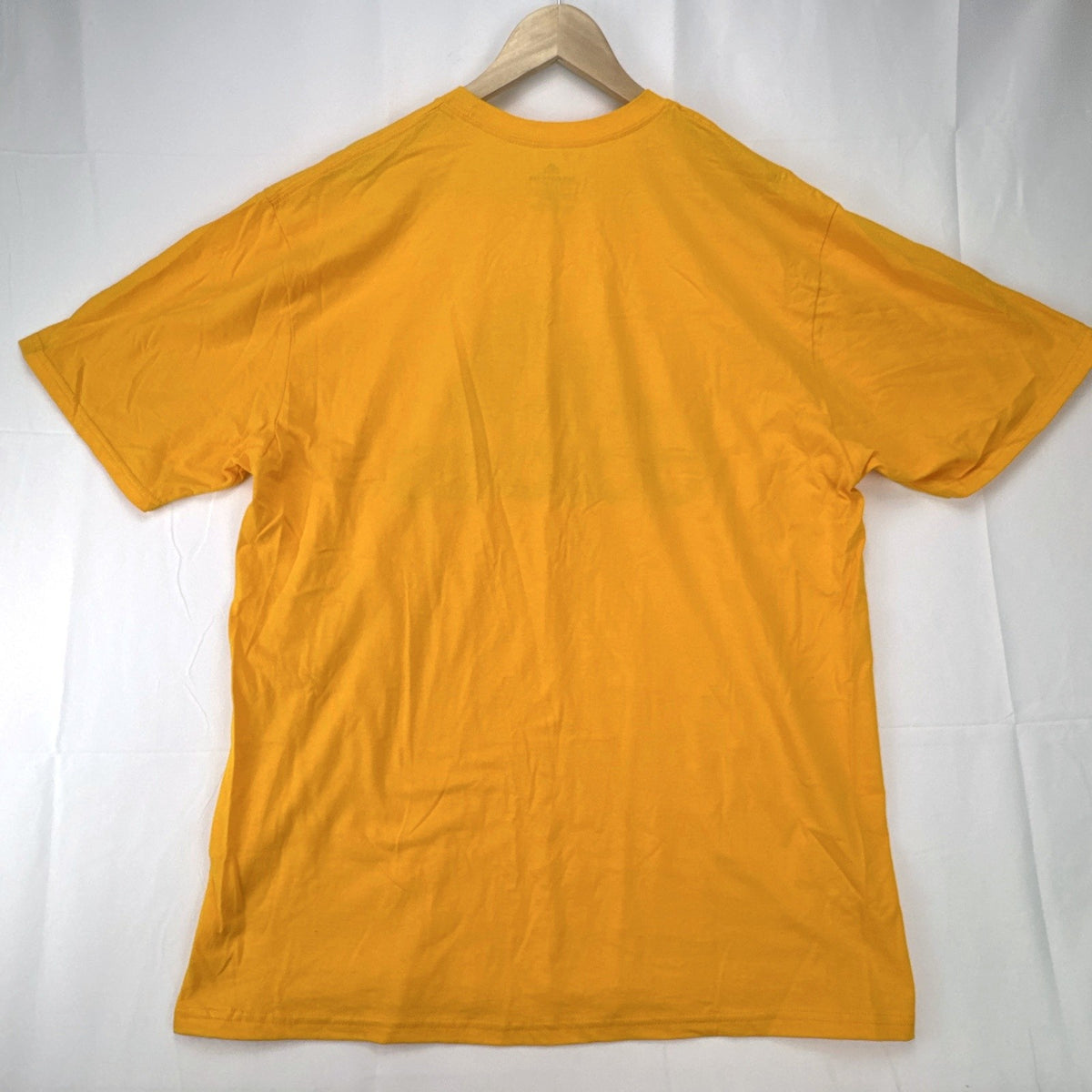 Front view of yellow adidas The Go-To graphic t-shirt in men's XL with black Badge of Sport logo