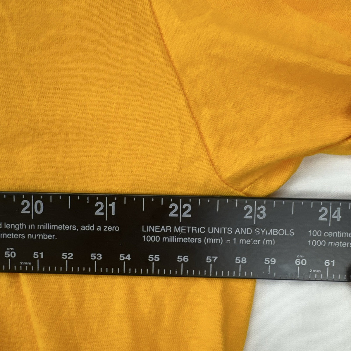 Front view of yellow adidas The Go-To graphic t-shirt in men's XL with black Badge of Sport logo