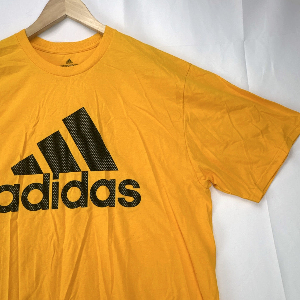 Front view of yellow adidas The Go-To graphic t-shirt in men's XL with black Badge of Sport logo