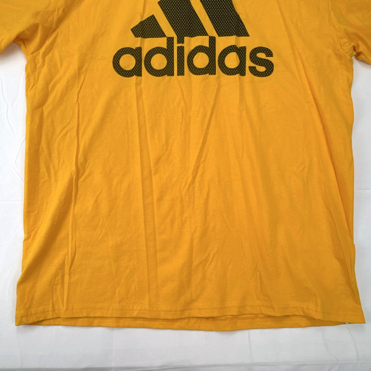 Front view of yellow adidas The Go-To graphic t-shirt in men's XL with black Badge of Sport logo