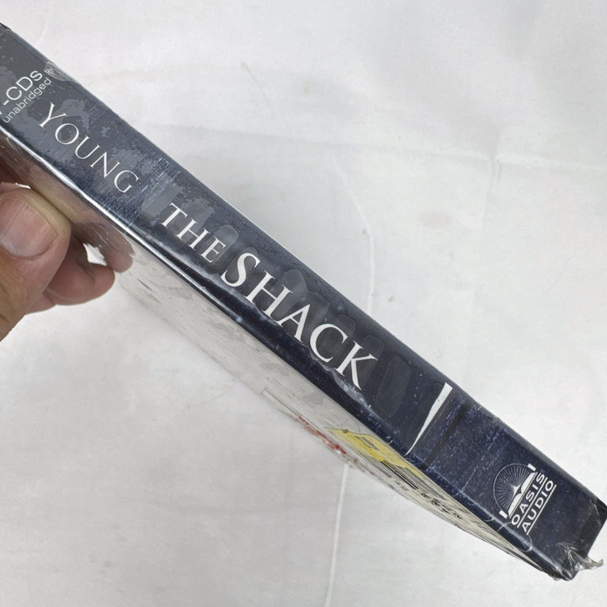Factory-sealed Oasis Audio unabridged CD edition of The Shack by William P. Young in tall clamshell packaging.