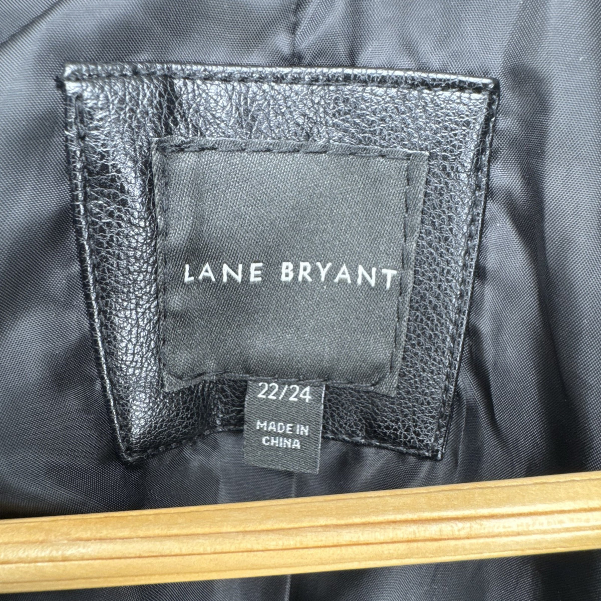 Lane Bryant women's plus size 22/24 black faux leather moto jacket with stretch knit sleeve panels.