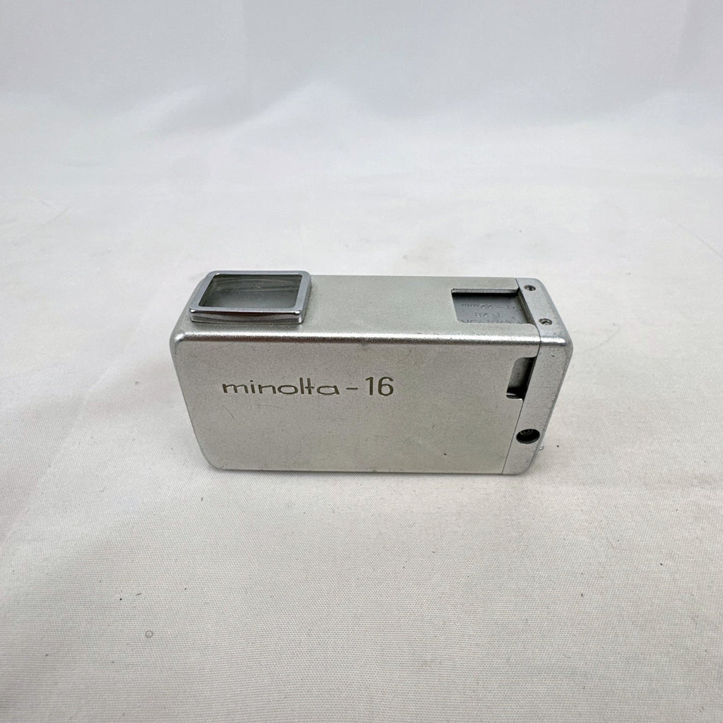 Vintage silver Minolta 16 II subminiature 16mm film camera showing Rokkor 22mm f/2.8 lens and metal push-pull body.