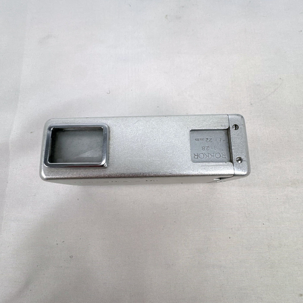 Vintage silver Minolta 16 II subminiature 16mm film camera showing Rokkor 22mm f/2.8 lens and metal push-pull body.