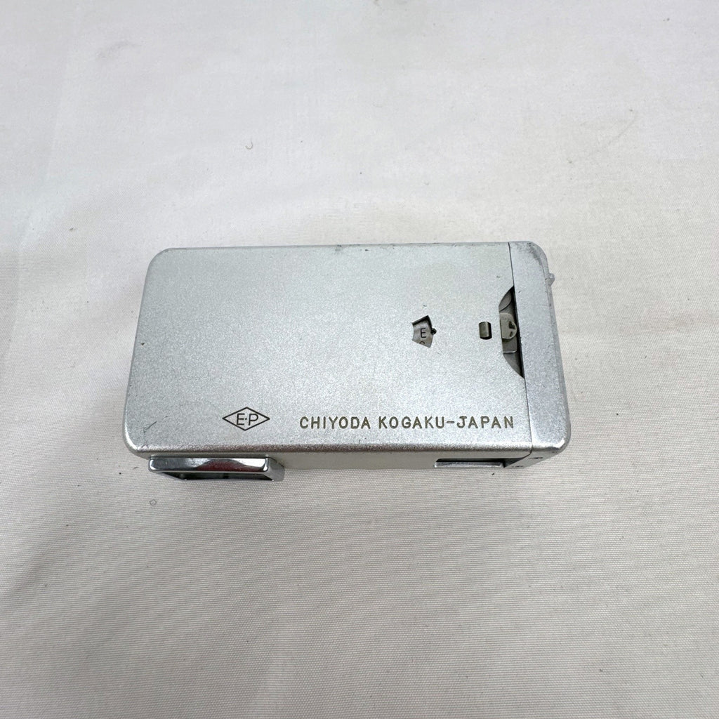 Vintage silver Minolta 16 II subminiature 16mm film camera showing Rokkor 22mm f/2.8 lens and metal push-pull body.
