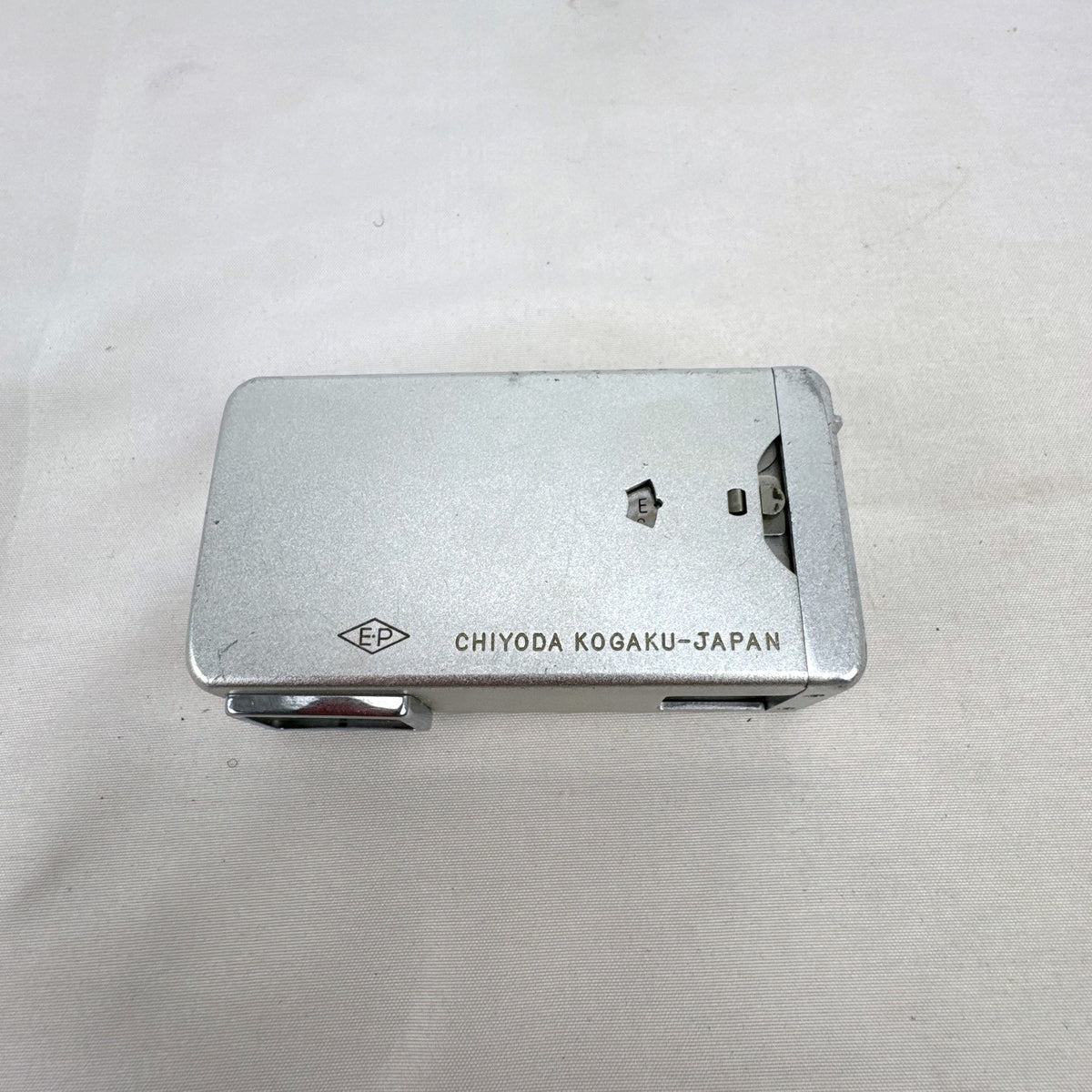 Vintage silver Minolta 16 II subminiature 16mm film camera showing Rokkor 22mm f/2.8 lens and metal push-pull body.