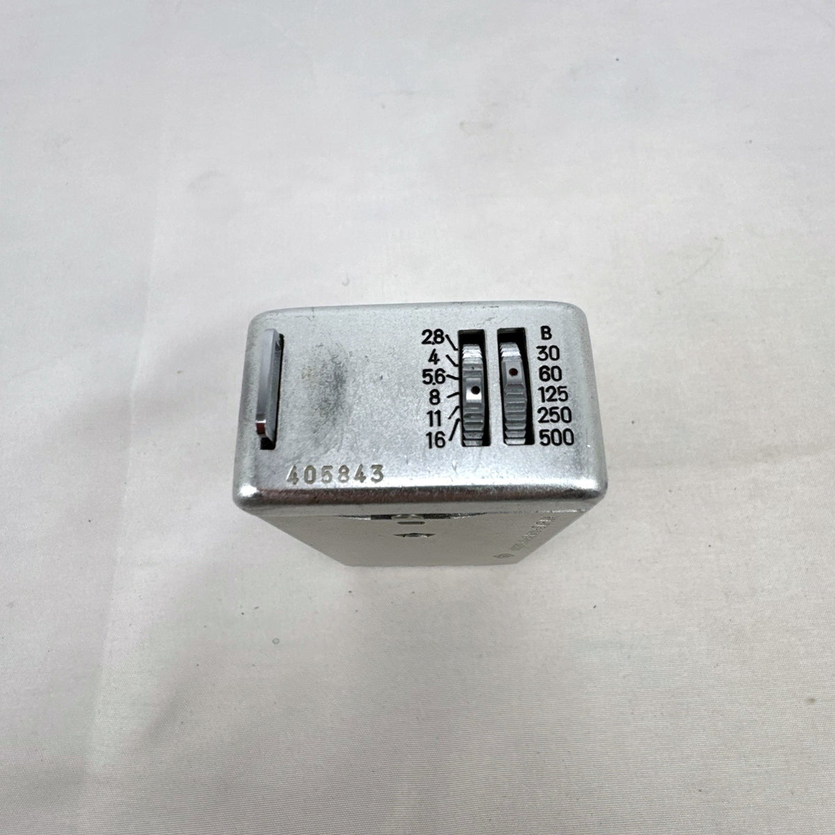Vintage silver Minolta 16 II subminiature 16mm film camera showing Rokkor 22mm f/2.8 lens and metal push-pull body.