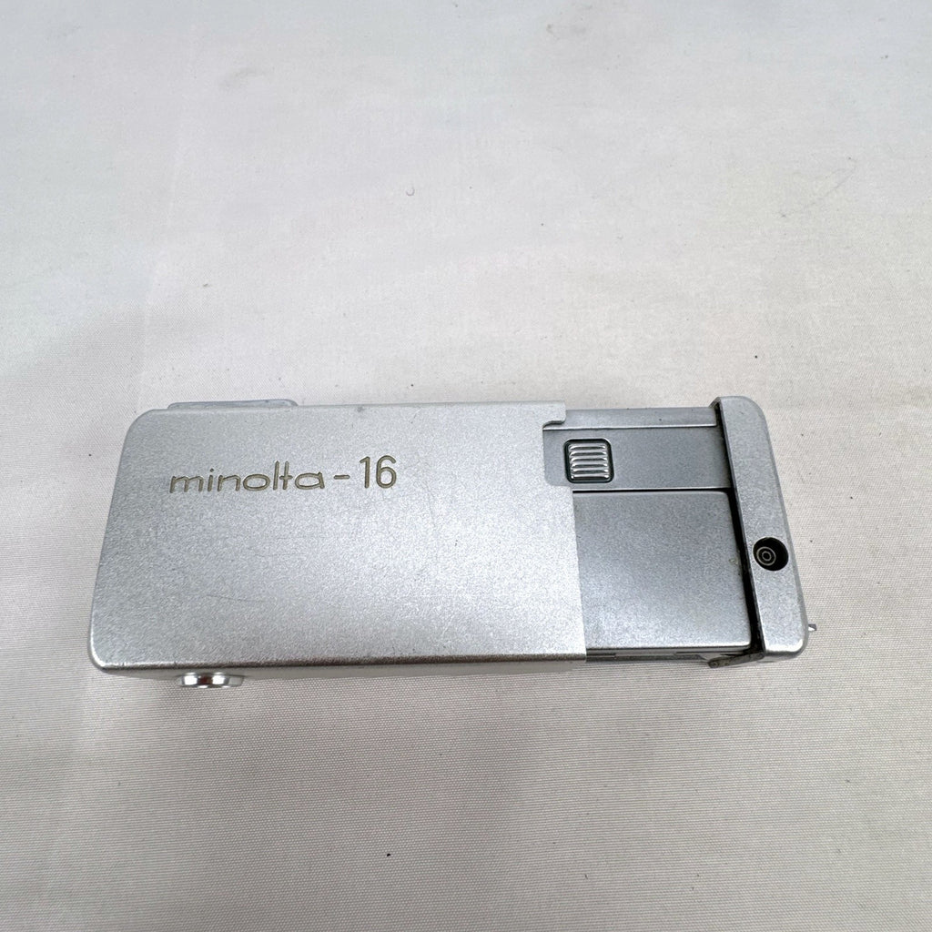 Vintage silver Minolta 16 II subminiature 16mm film camera showing Rokkor 22mm f/2.8 lens and metal push-pull body.