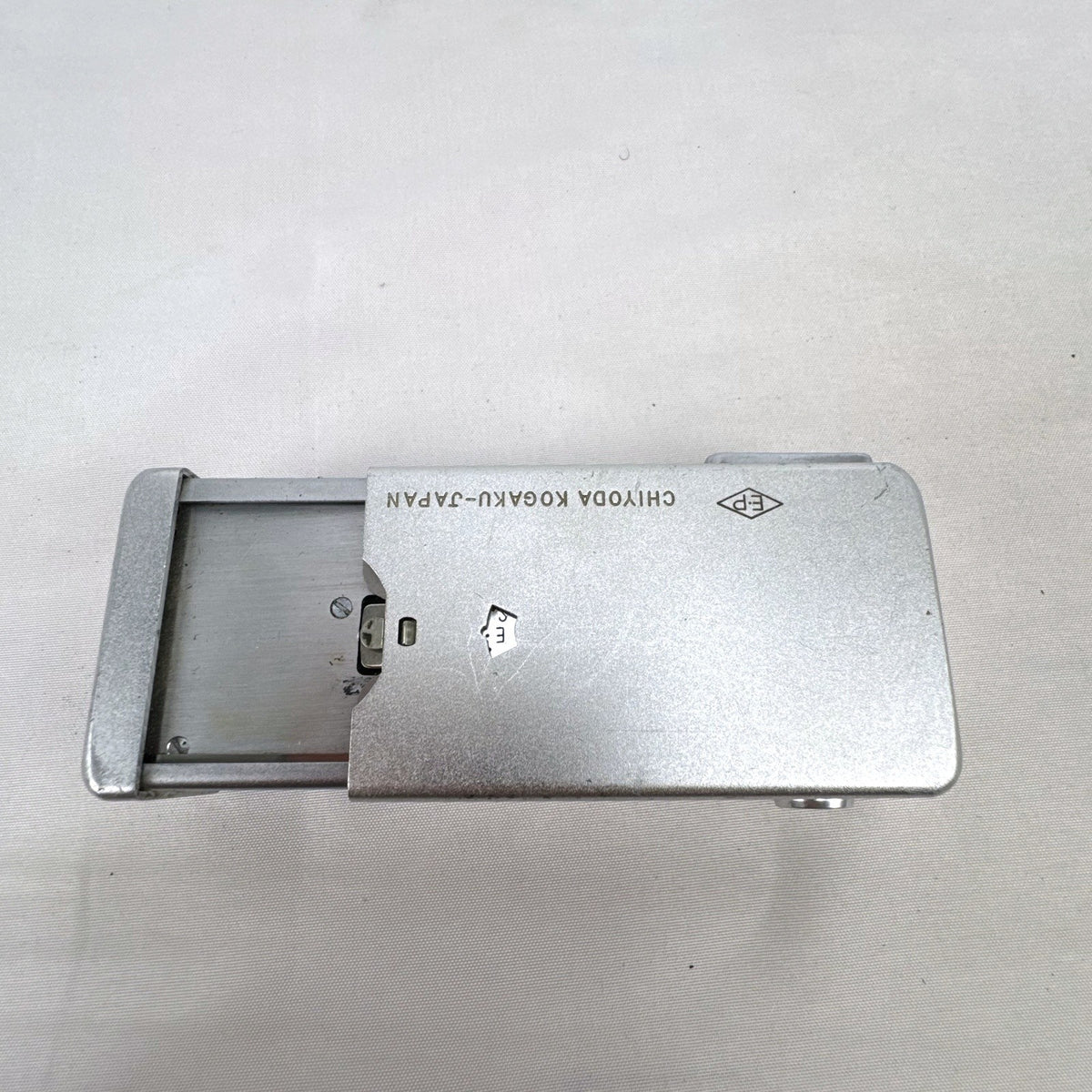 Vintage silver Minolta 16 II subminiature 16mm film camera showing Rokkor 22mm f/2.8 lens and metal push-pull body.
