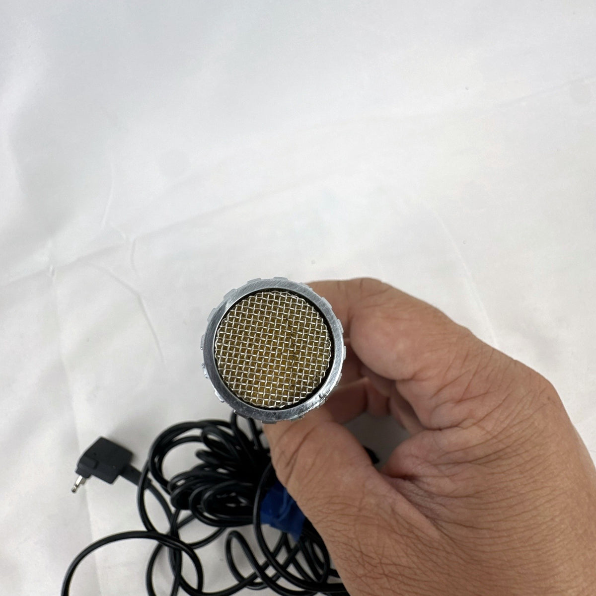 Black Canon DM 30R dynamic handheld microphone with chrome grille and attached 3.5mm cable