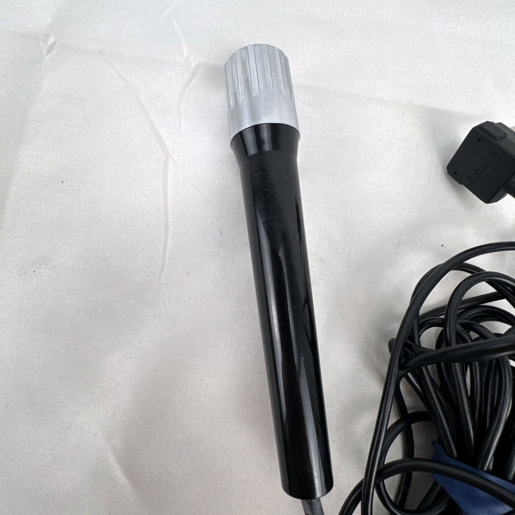 Black Canon DM 30R dynamic handheld microphone with chrome grille and attached 3.5mm cable
