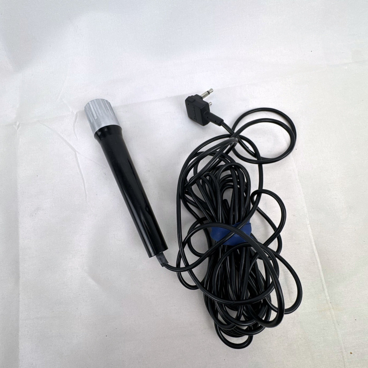 Black Canon DM 30R dynamic handheld microphone with chrome grille and attached 3.5mm cable
