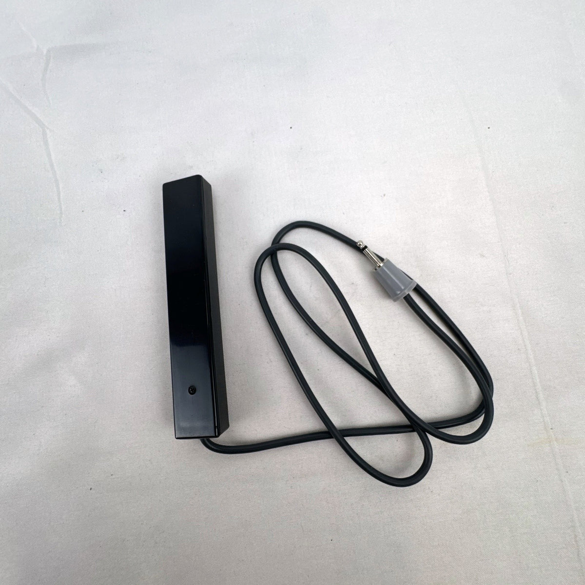 Black vintage Canon wired shutter release remote switch with 2.5mm connector plug and running lock.
