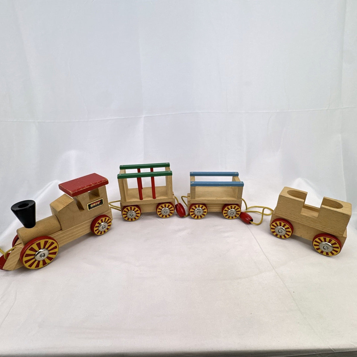 Vintage BRIO Swedish wooden pull toy train with locomotive and three connected wagons