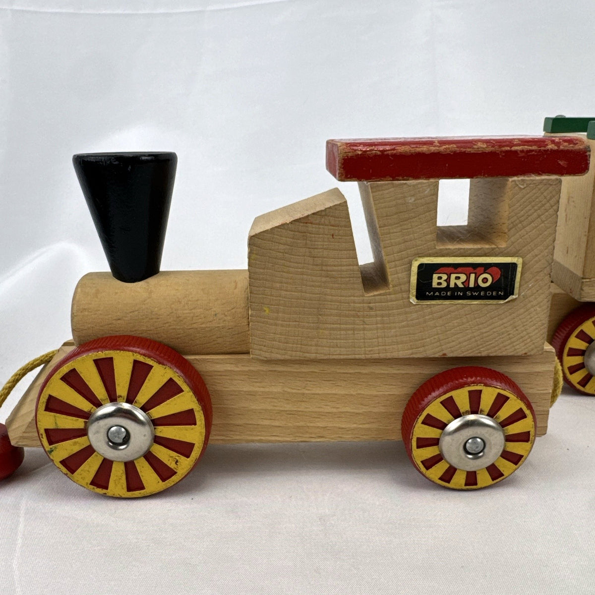 Vintage BRIO Swedish wooden pull toy train with locomotive and three connected wagons