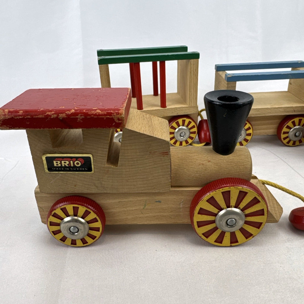 Vintage BRIO Swedish wooden pull toy train with locomotive and three connected wagons