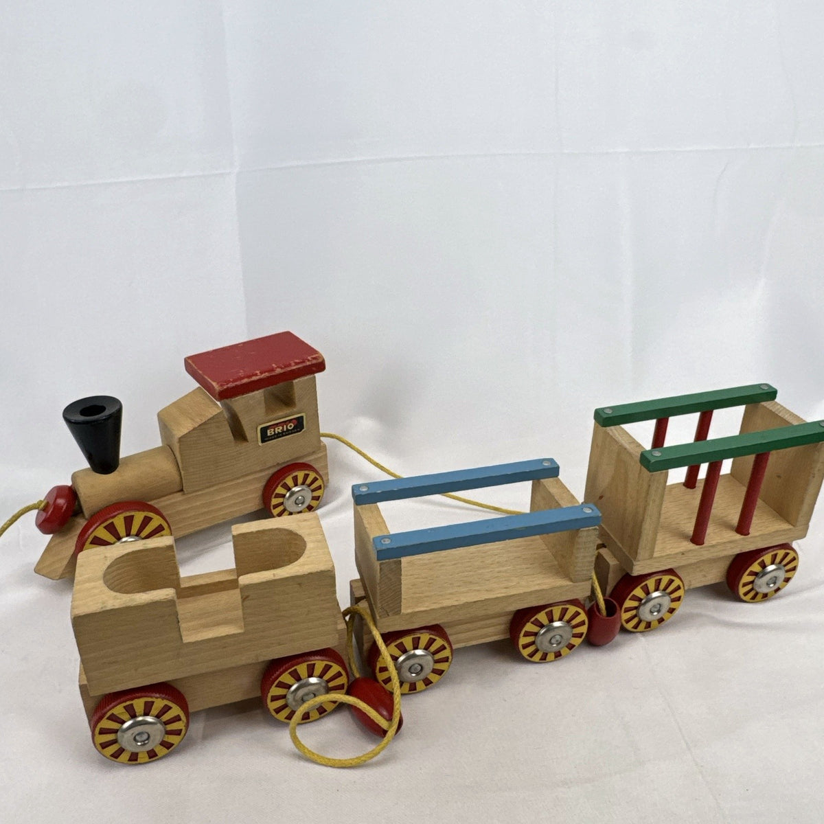 Vintage BRIO Swedish wooden pull toy train with locomotive and three connected wagons
